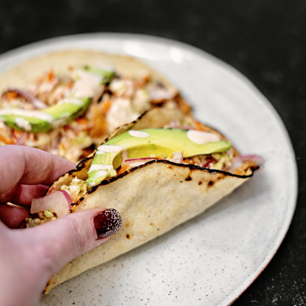 hand holding homemade taco, homemade tortilla tacos, soft jackfruit taco